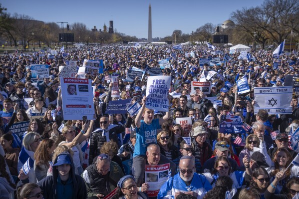 Participants hold signs as they stand on the Natio<em></em>nal Mall at the March for Israel on Tuesday, Nov. 14, 2023, in Washington. (AP Photo/Mark Schiefelbein)