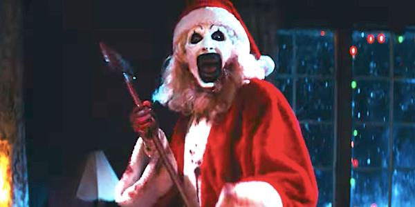 Art the Clown dressed as Santa Claus holding an axe in Terrifier 3's trailer