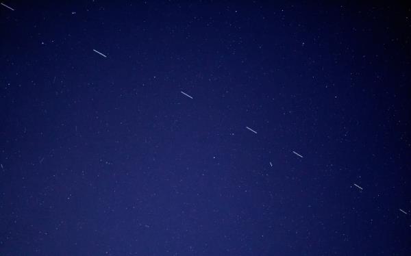 The Starl<em></em>ink 3 train rides across the early morning sky, accompanied by a handful of other satellites.