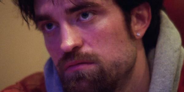 Close up of Robert Pattinson looking gruff in Good Time