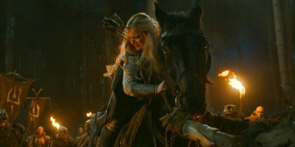 Galadriel (Morfydd Clark) on her horse, fighting against an army of orcs in The Lord of the Rings: The Rings of Power Season 2 Episode 4