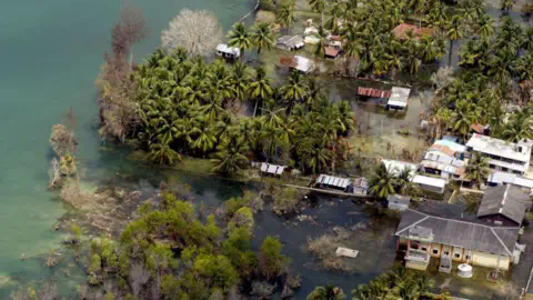 Getty Images This aerial view from an Indian Navy Helicopter taken 28 February 2005, shows an abando<em></em>ned waterlogged coastal village on Kamorta Island, part of the Andaman and Nicobar Islands. India has given up hope of rebuilding six islands in the tsunami-hit Andaman and Nicobar archipelago wher<em></em>e 5764 people are still listed as missing and some 40,500 people are placed in makeshift camps waiting for their homes to be rebuilt by the Integrated Relief Command (IRC), comprising the military and the civilian administration, set up by India to restore the Andamans. 