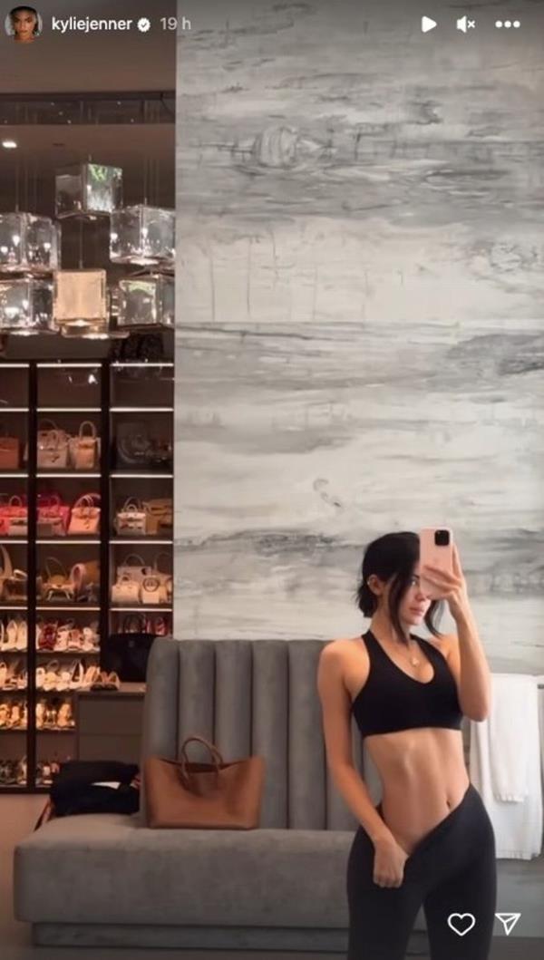 Fans could see a wall of designer handbags in the background