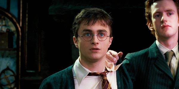 Daniel Radcliffe as Harry Potter looking nervous with Percy (Chris Rankin) placing his hand on his shoulder in Harry Potter and the Order of the Phoenix