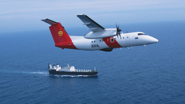 A Cobham Dash 8 aircraft, pictured above a Border Force ship, co<em></em>nducts aerial surveillance.