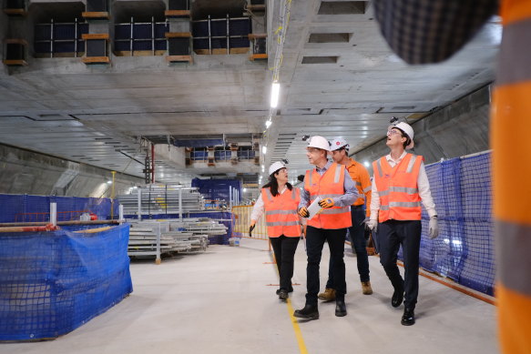 Deputy Premier Cameron Dick, State Development Minister Grace Grace and Transport Minister Bart Mellish tour the Albert Street station’s now-co<em></em>nstructed platform and mezzanine level above.