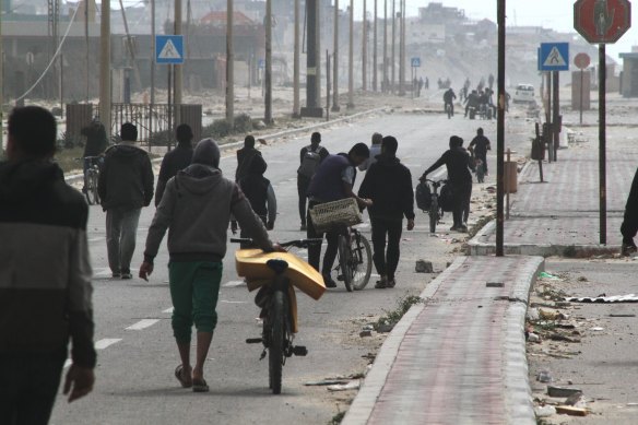 Displaced Palestinians on the coastal road after fleeing the Al-Shifa hospital area in north Gaza.