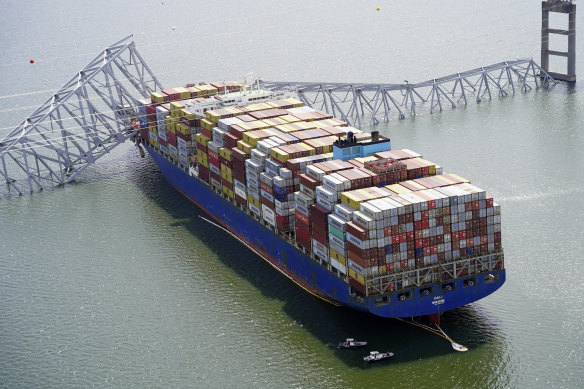 The cargo ship Dali is stuck under part of the structure of the Francis Scott Key Bridge after the ship hit the bridge in Baltimore. 